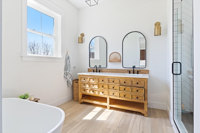 1222 Rock Church Rd, Dickson, TN 37055 - full bathroom with double vanity, a shower stall, a soaking tub, and wood finished floors