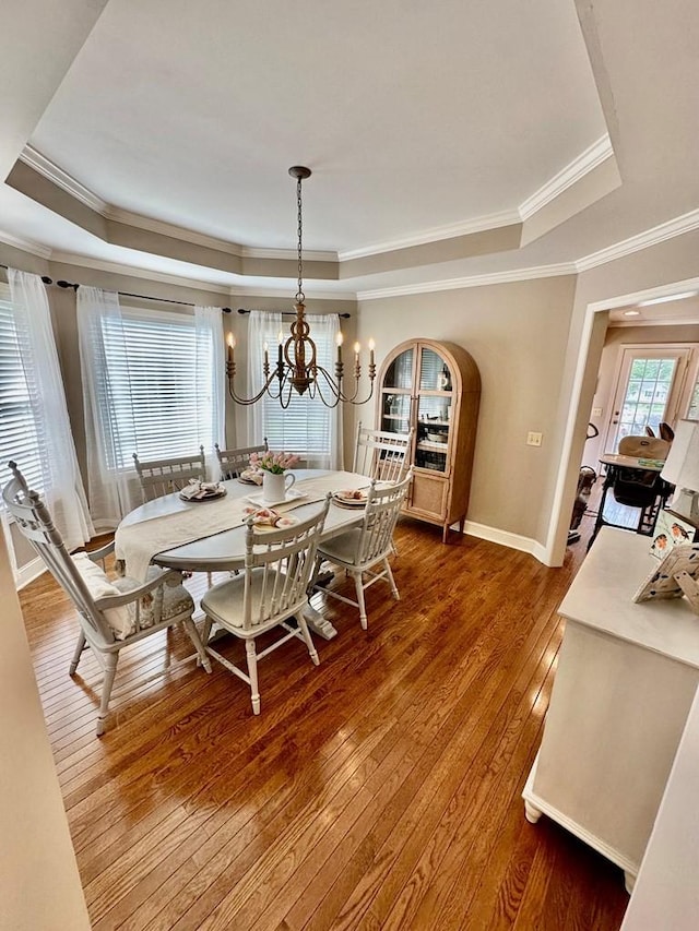 593 Imperial Dr, Sparta, TN 38583 - dining area with a tray ceiling, a chandelier, ornamental molding, hardwood / wood-style floors, and baseboards