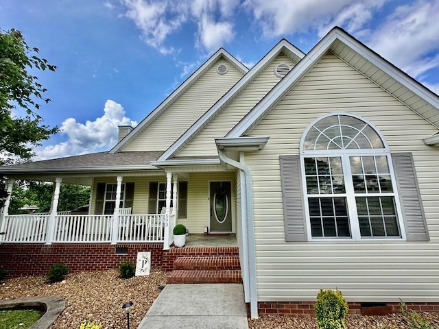 593 Imperial Dr, Sparta, TN 38583 - view of front of home with covered porch, crawl space, and a chimney