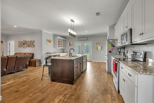 1034 Salem Rd, Lebanon, TN 37090 - kitchen with stainless steel appliances, a sink, wood finished floors, french doors, and ornamental molding