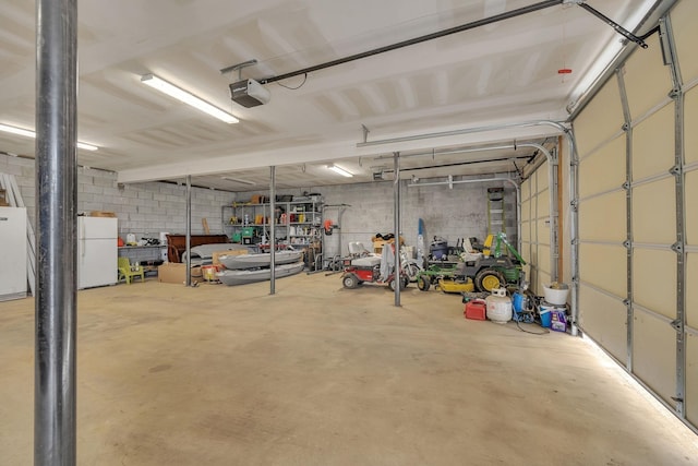 1034 Salem Rd, Lebanon, TN 37090 - garage featuring freestanding refrigerator and a garage door opener