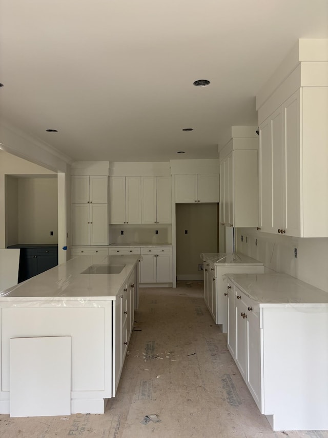 306 Oaks Xing, Lebanon, TN 37087 - kitchen with white cabinetry, a spacious island, and stovetop