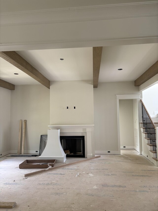 306 Oaks Xing, Lebanon, TN 37087 - unfurnished living room featuring beamed ceiling, stairway, and a glass covered fireplace