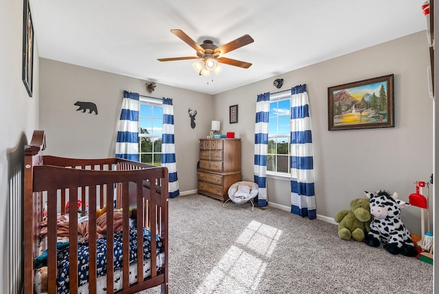 1310 Ray Broyles Rd, Sparta, TN 38583 - carpeted bedroom featuring a nursery area, baseboards, and a ceiling fan