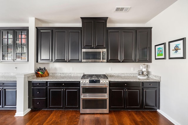6050 Huntmere Ave, Franklin, TN 37064 - kitchen featuring appliances with stainless steel finishes, dark cabinets, and dark wood finished floors