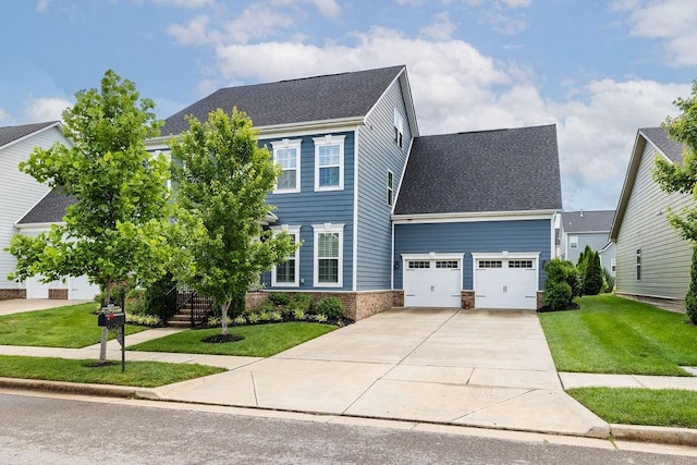 6050 Huntmere Ave, Franklin, TN 37064 - colonial home featuring a garage, concrete driveway, a front lawn, and roof with shingles