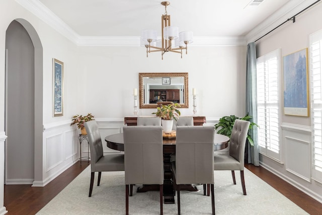 6050 Huntmere Ave, Franklin, TN 37064 - dining room with wood finished floors, healthy amount of natural light, a chandelier, arched walkways, and ornamental molding