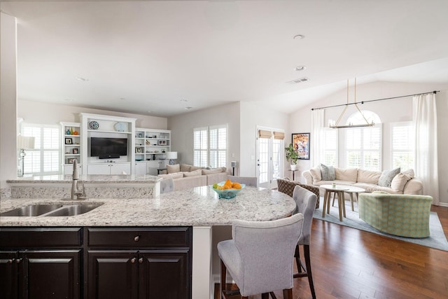 6050 Huntmere Ave, Franklin, TN 37064 - kitchen with open floor plan, a sink, dark wood-type flooring, light stone countertops, and a breakfast bar
