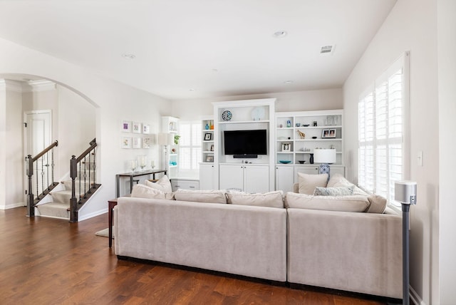 6050 Huntmere Ave, Franklin, TN 37064 - living room with arched walkways, dark wood finished floors, stairs, baseboards, and recessed lighting