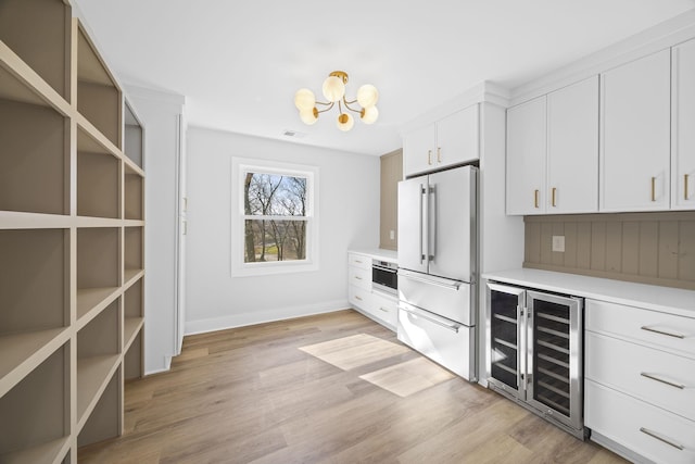 6608 Brookmont Ter, Nashville, TN 37205 - kitchen with high end fridge, light countertops, a chandelier, wine cooler, and light wood-type flooring