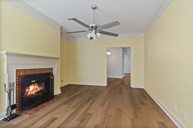 2101 Benton Hall Ct, Columbia, TN 38401 - unfurnished living room with ornamental molding, a brick fireplace, a ceiling fan, wood finished floors, and baseboards