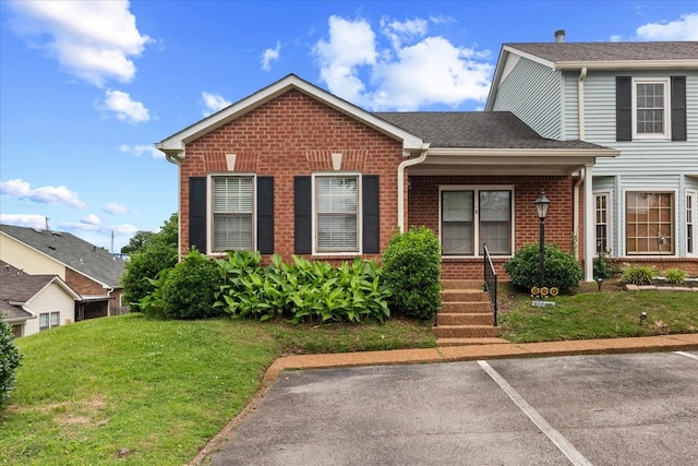 2101 Benton Hall Ct, Columbia, TN 38401 - view of front of property featuring brick siding, a front lawn, covered porch, and uncovered parking