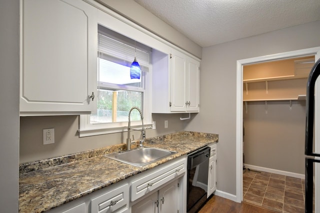 545 Donna Dr, Clarksville, TN 37042 - kitchen with black dishwasher, a sink, white cabinetry, a textured ceiling, and baseboards