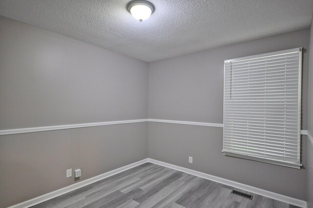 545 Donna Dr, Clarksville, TN 37042 - spare room featuring wood finished floors, a textured ceiling, and baseboards