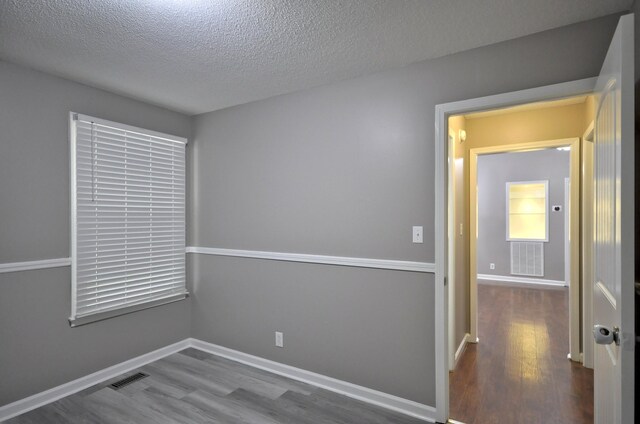 545 Donna Dr, Clarksville, TN 37042 - unfurnished room with wood finished floors, a textured ceiling, and baseboards