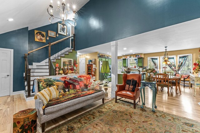 1313 Stayton Rd, Cumberland Furnace, TN 37051 - living room featuring wood finished floors, a chandelier, stairway, ornate columns, and recessed lighting