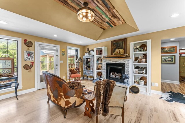1313 Stayton Rd, Cumberland Furnace, TN 37051 - living area with light wood-style flooring, a stone fireplace, baseboards, recessed lighting, and built in shelves