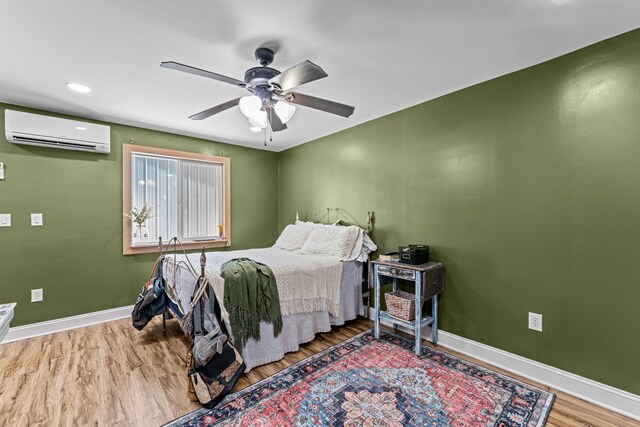 1313 Stayton Rd, Cumberland Furnace, TN 37051 - bedroom featuring a wall mounted AC, wood finished floors, baseboards, and ceiling fan