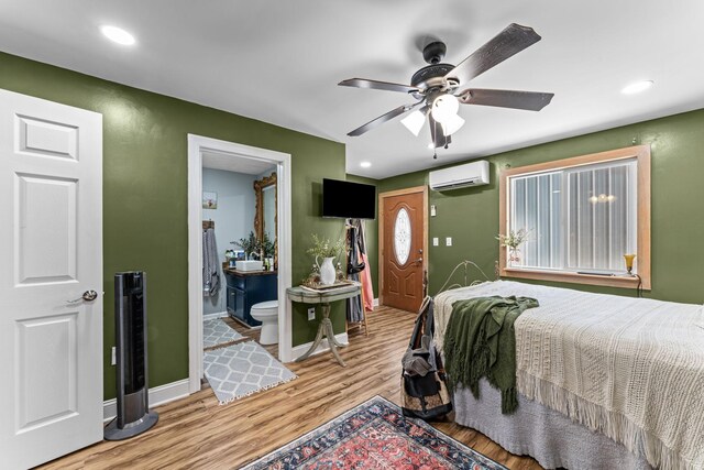 1313 Stayton Rd, Cumberland Furnace, TN 37051 - bedroom featuring a wall unit AC, baseboards, light wood-style flooring, recessed lighting, and ensuite bath