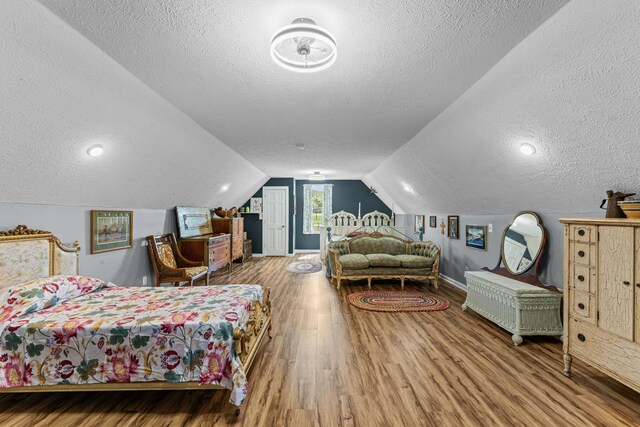 1313 Stayton Rd, Cumberland Furnace, TN 37051 - bedroom featuring a textured ceiling, wood finished floors, baseboards, and lofted ceiling