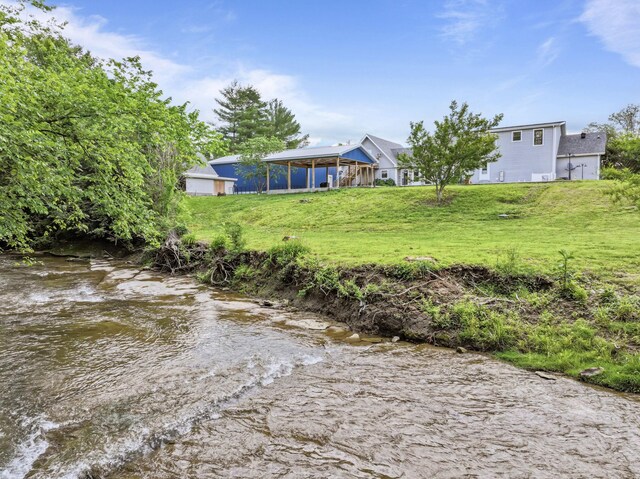 1313 Stayton Rd, Cumberland Furnace, TN 37051 - view of grassy yard featuring a water view and a sunroom