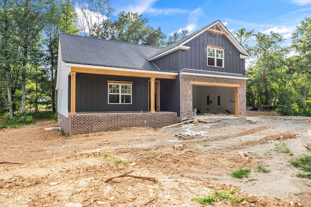 1586 Ryes Chapel Rd, Southside, TN 37171 - modern farmhouse featuring board and batten siding, brick siding, a porch, and an attached garage