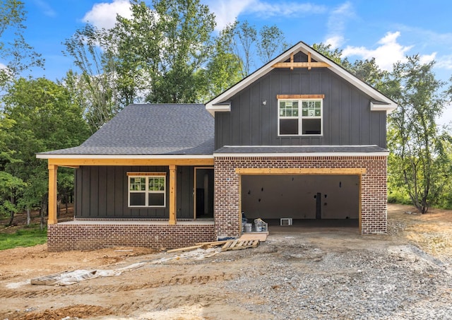 1586 Ryes Chapel Rd, Southside, TN 37171 - view of front of home featuring board and batten siding, a garage, and brick siding