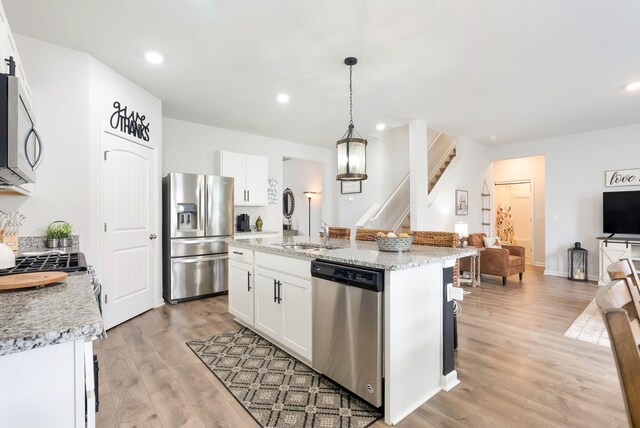 4043 Beach Way, White House, TN 37188 - kitchen with appliances with stainless steel finishes, light wood-style flooring, a sink, open floor plan, and an island with sink