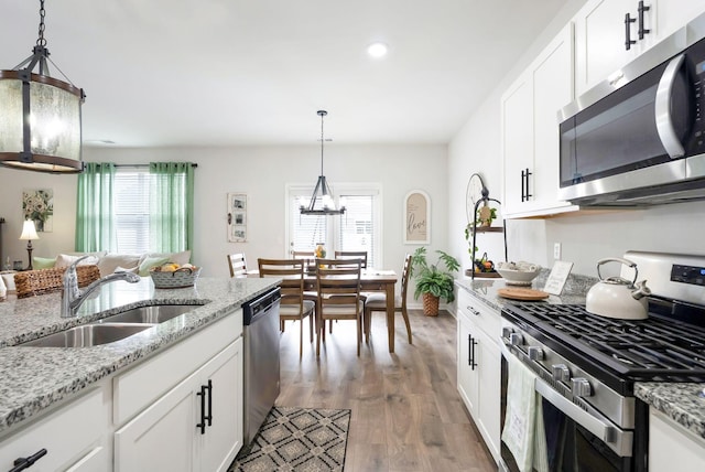 4043 Beach Way, White House, TN 37188 - kitchen featuring stainless steel appliances, a sink, a chandelier, plenty of natural light, and recessed lighting