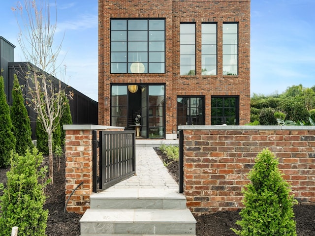 1302 Pillow St, Nashville, TN 37203 - view of front of house featuring brick siding, a gate, and a fenced front yard