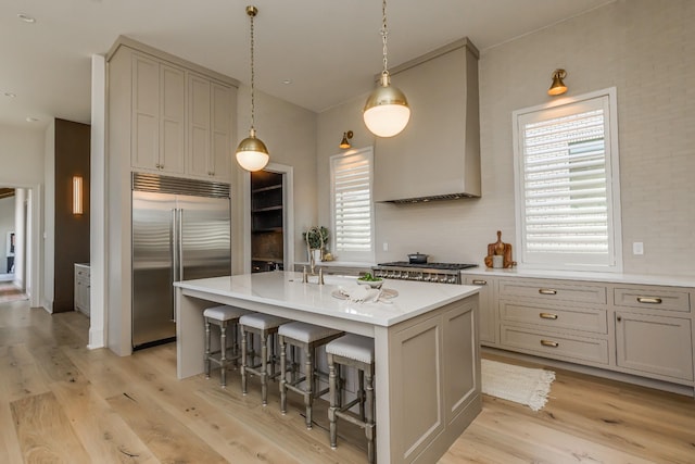 1302 Pillow St, Nashville, TN 37203 - kitchen featuring stainless steel appliances, light wood-style floors, healthy amount of natural light, and an island with sink