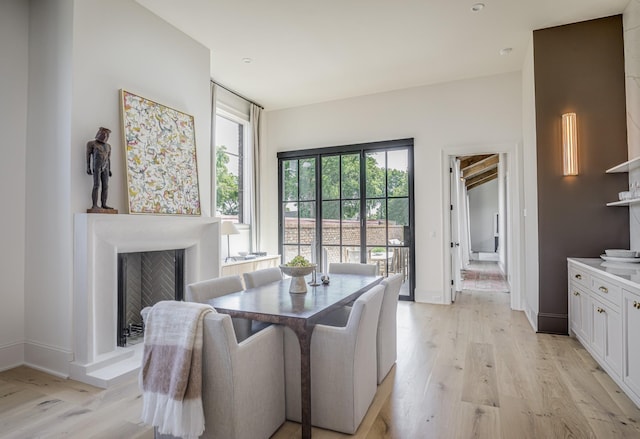 1302 Pillow St, Nashville, TN 37203 - dining area featuring light wood-type flooring, a fireplace, and baseboards