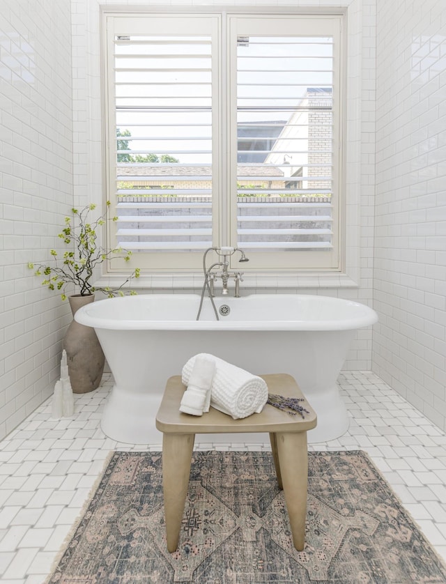 1302 Pillow St, Nashville, TN 37203 - full bath featuring tile walls, tile patterned flooring, healthy amount of natural light, and a freestanding tub