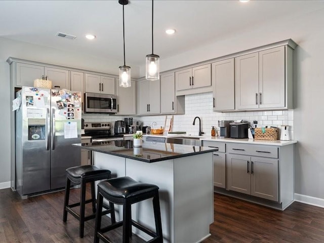 401 Queen Ln, Gallatin, TN 37066 - kitchen with appliances with stainless steel finishes, gray cabinets, tasteful backsplash, dark wood-style flooring, and recessed lighting