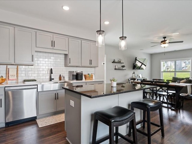 401 Queen Ln, Gallatin, TN 37066 - kitchen with stainless steel dishwasher, a sink, gray cabinetry, decorative backsplash, and recessed lighting