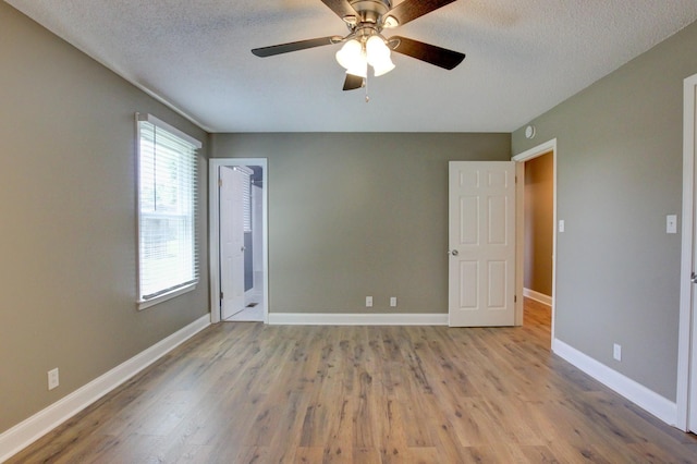 1783 Forrestdale Dr, Clarksville, TN 37042 - unfurnished room featuring wood finished floors, a ceiling fan, a textured ceiling, and baseboards