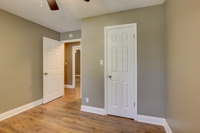 1783 Forrestdale Dr, Clarksville, TN 37042 - unfurnished bedroom featuring light wood-style floors, baseboards, ceiling fan, and a textured ceiling