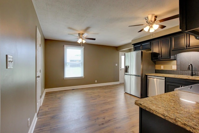 1783 Forrestdale Dr, Clarksville, TN 37042 - kitchen featuring appliances with stainless steel finishes, a ceiling fan, a sink, light wood-style flooring, and a textured ceiling