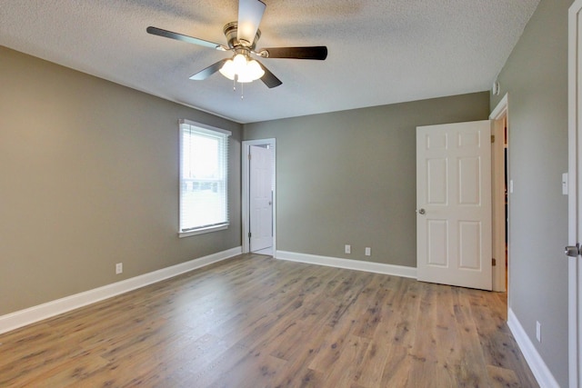 1783 Forrestdale Dr, Clarksville, TN 37042 - unfurnished room with wood finished floors, ceiling fan, a textured ceiling, and baseboards