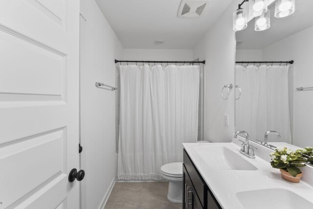 285 Gulfstream Dr, Gallatin, TN 37066 - bathroom with double vanity, toilet, a shower with curtain, and tile patterned floors