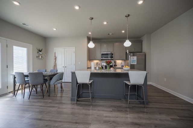 430 Burnley Way, Murfreesboro, TN 37128 - kitchen with appliances with stainless steel finishes, gray cabinets, an island with sink, a kitchen breakfast bar, and recessed lighting