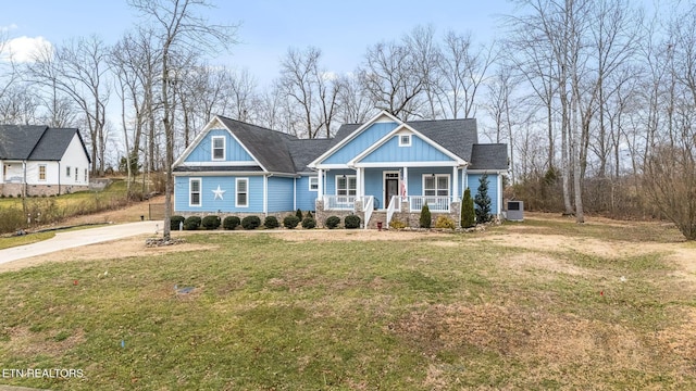 569 Station Circle Cir, Tullahoma, TN 37388 - view of front of property with a porch, concrete driveway, stone siding, a front lawn, and board and batten siding
