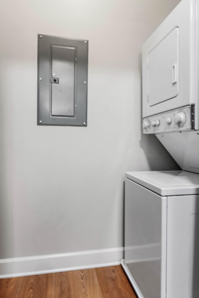 8221 Lenox Creekside Dr Unit 10, Antioch, TN 37013 - laundry room with stacked washing machine and dryer, electric panel, baseboards, and wood finished floors