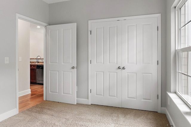 8221 Lenox Creekside Dr Unit 10, Antioch, TN 37013 - unfurnished bedroom featuring carpet, a closet, a sink, and baseboards