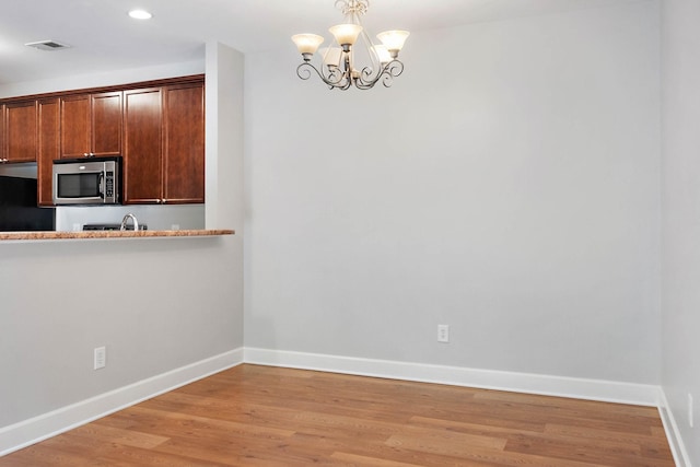 8221 Lenox Creekside Dr Unit 10, Antioch, TN 37013 - unfurnished dining area with a chandelier, baseboards, light wood finished floors, and recessed lighting
