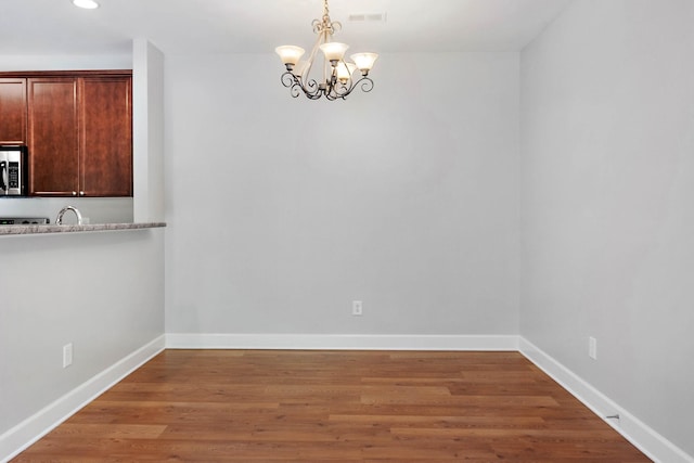 8221 Lenox Creekside Dr Unit 10, Antioch, TN 37013 - unfurnished dining area featuring a chandelier, light wood finished floors, baseboards, recessed lighting, and a sink