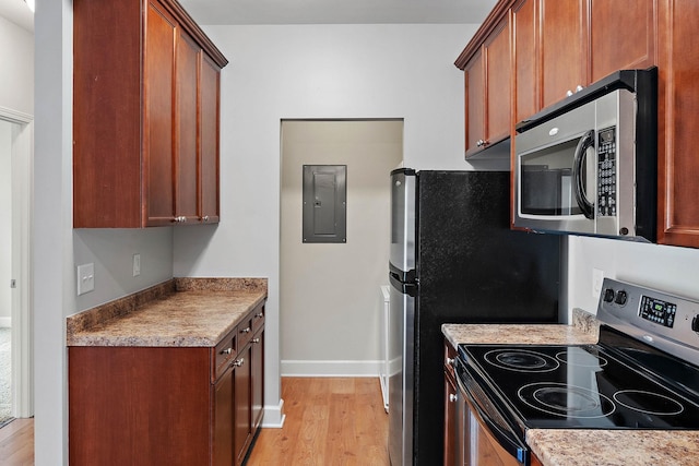 8221 Lenox Creekside Dr Unit 10, Antioch, TN 37013 - kitchen featuring appliances with stainless steel finishes, light wood-type flooring, electric panel, and baseboards