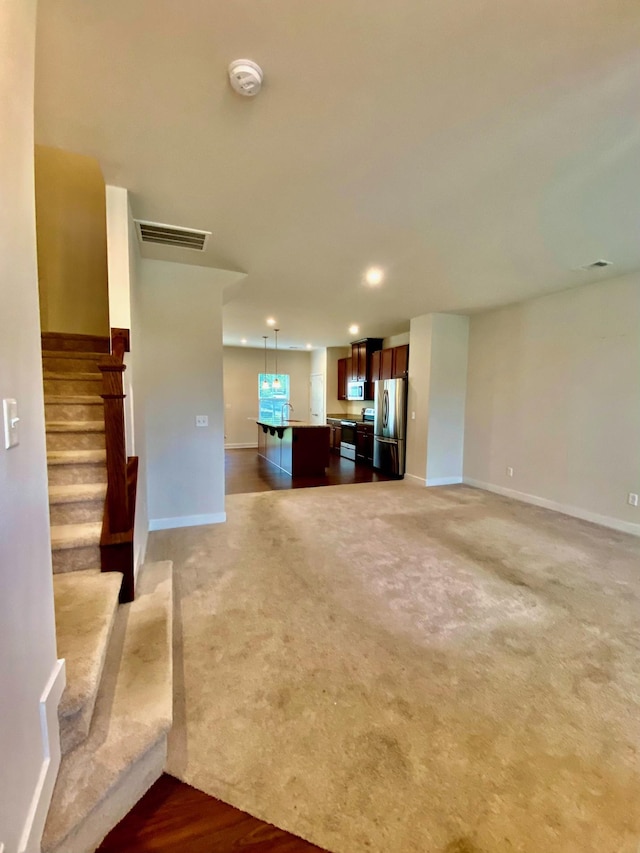 4316 Summercrest Blvd Unit 800, Antioch, TN 37013 - unfurnished living room with baseboards, recessed lighting, light colored carpet, and stairway
