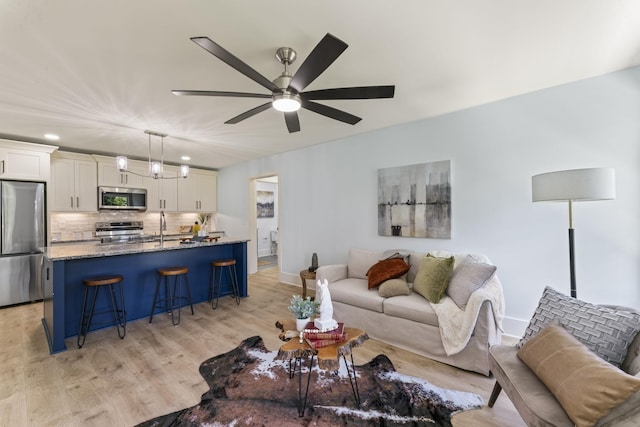 712 N 5th St, Nashville, TN 37207 - living room with light wood-style floors, ceiling fan, recessed lighting, and baseboards