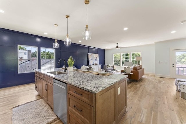 712 N 5th St, Nashville, TN 37207 - kitchen featuring stainless steel dishwasher, a sink, brown cabinets, light wood-style flooring, and a ceiling fan
